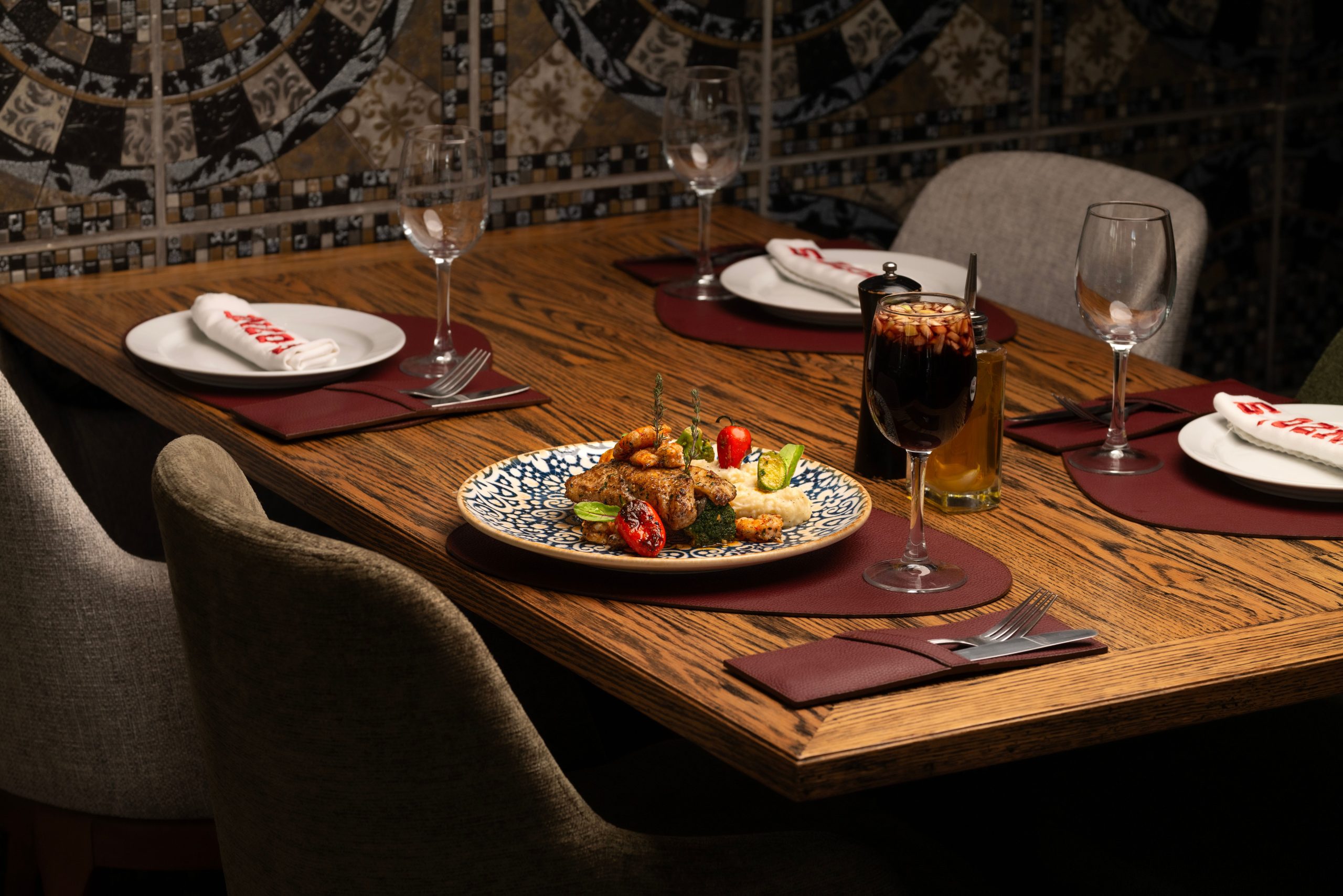 Cozy restaurant table setting with elegant appetizers and wine, ideal for a fine dining experience.